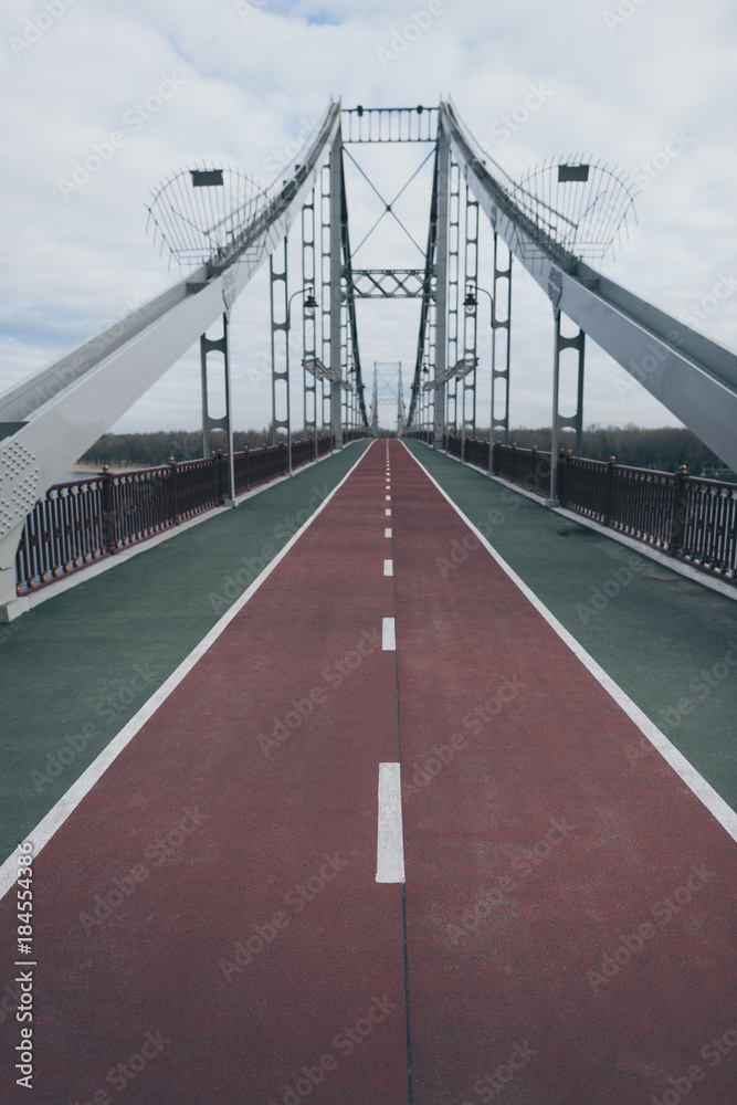 empty pedestrian bridge on cloudy autumn day empty pedestrian bridge on cloudy autumn day