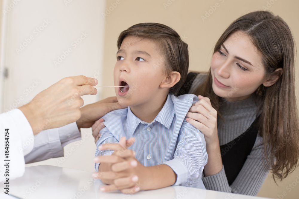 Doctor checking to inside boy mouth at clinic. People with medical concept. Doctor checking to inside boy mouth at clinic. People with medical concept.