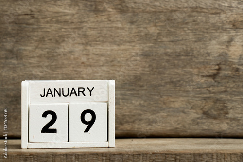 White block calendar present date 29 and month January on wood background