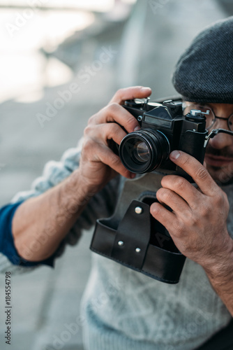close-up shot of handsome adult man with vintage film camera outdoors © LIGHTFIELD STUDIOS