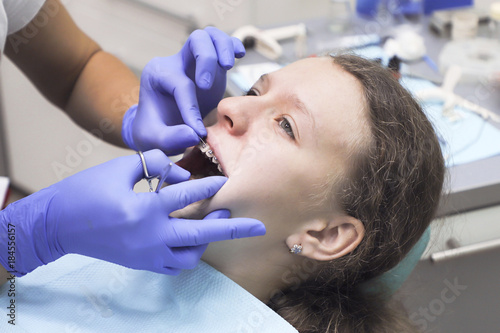 Teenage girl at a dentist s reception. Dental treatment  braces 