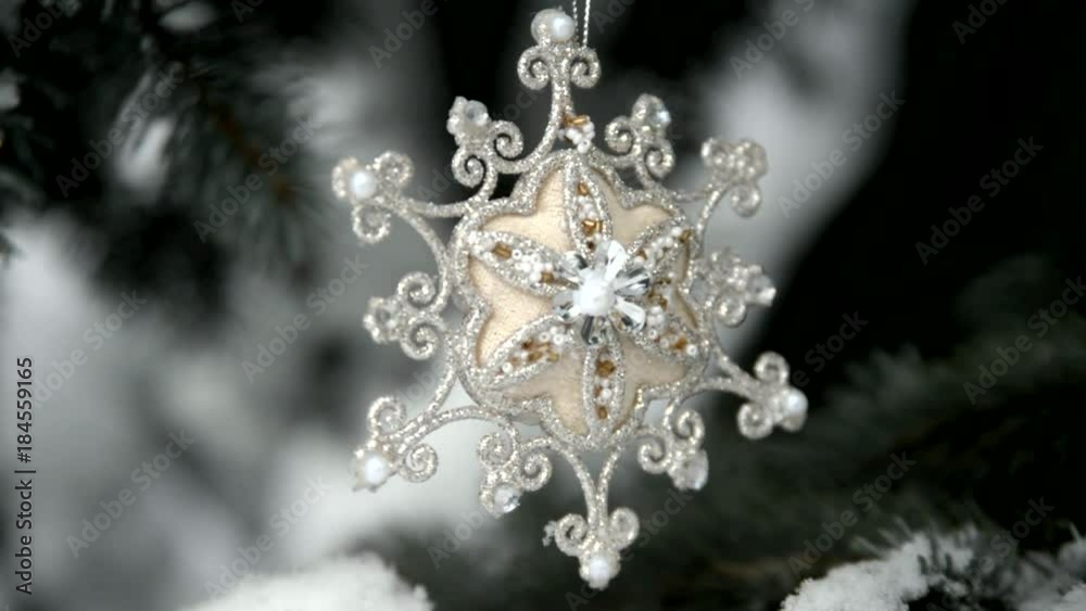Christmas star hanging on the branches of a snow-covered tree 