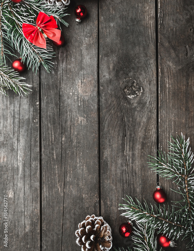 Wallpaper Mural Vertical Christmas theme with fir branches, red bows and globes, cones, on rustic dark wooden background viewed from above, top, greeting card with space for text Torontodigital.ca