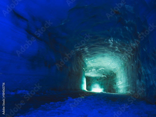 Tunnel with light inside ice cave in the Langjokull glacier in Iceland