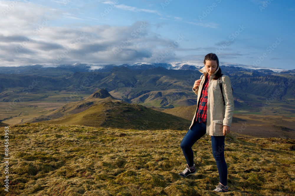 Young woman in the mountains, alone with nature
