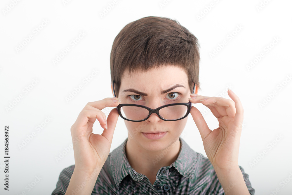 A young woman wearing glasses. Glasses woman showing eyewear happy holding glasses frame. Closeup of young caucasian woman A young woman wearing glasses. Glasses woman showing eyewear happy holding glasses frame. Closeup of young caucasian woman