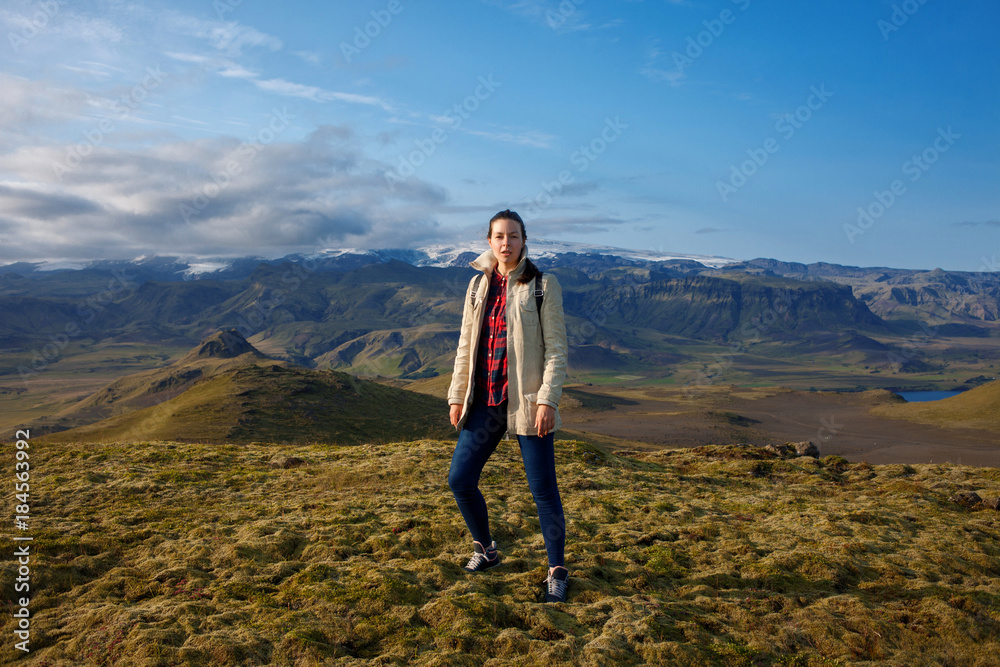 Attractive girl tourist on background of mountain landscape