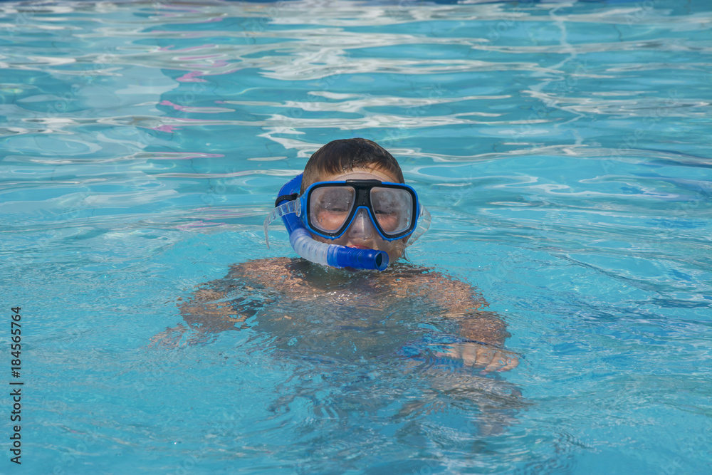 The little boy in the water with diving equipment
