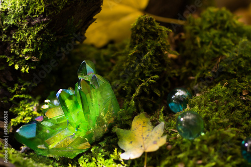Glittering green magical crystals in the forest