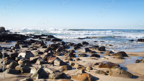 Fototapeta Naklejka Na Ścianę i Meble -  Boulders on the beach in Atlantic Ocean surf at Porto, Portugal