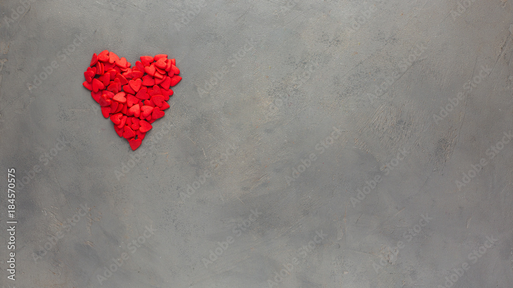 Valentines day background with  red heart. Sweet candy hearts on a gray concrete background. Romantic mood.) Beautiful background. Flat lay, top view