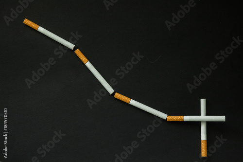 Fototapeta Naklejka Na Ścianę i Meble -  Cigarette on a dark background. quit Smoking