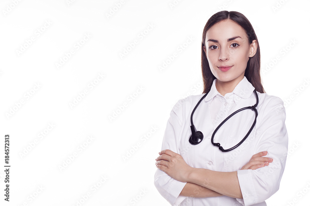 Modern Woman doctor with stethoscope and crossed hands looking into the camera isolated on white background with copyspace. Modern Woman doctor with stethoscope and crossed hands looking into the camera isolated on white background with copyspace.