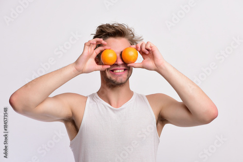 Healthy nutrition concept. Athlete with messy hair holds fresh fruit © be free