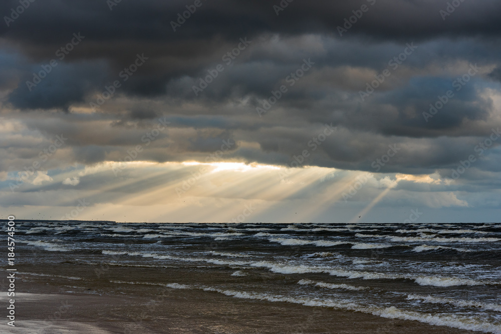 Sun beams in stormy sky, Baltic sea, Latvia.