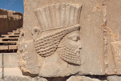 Ruined portrait of persian man with beard. Relief on wall of abandoned city Persepolis, capital of Achaemenid Empire, 550 - 330 BC