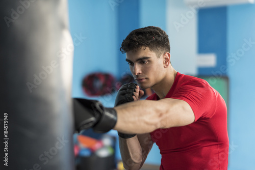 Boxer in gym training with punching bag © FotoAndalucia