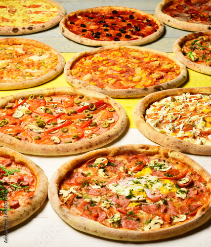 Pizza circles with meat, mushrooms, tomatoes and cheese