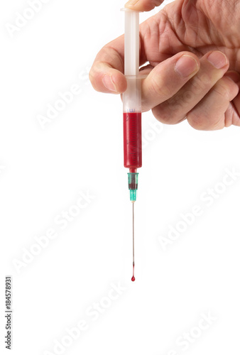 hand holding a syringe containing blood  and squeezes a drop of blood out of it  isolated on white
