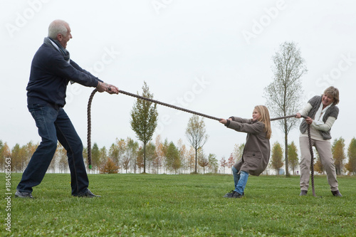Bild auf Leinwand Seniors playing tug-of-war