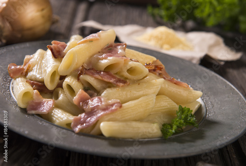 Pasta with cheese sauce and bacon photo