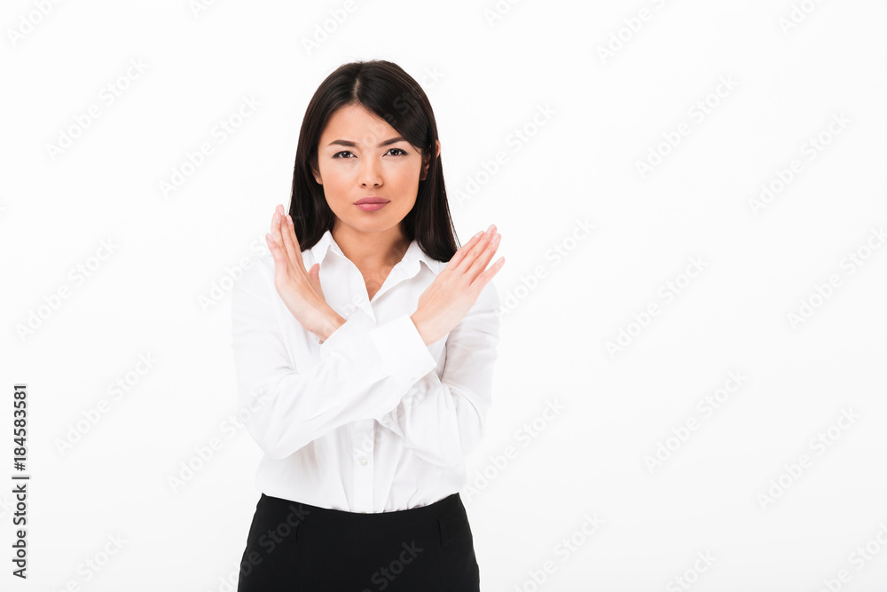 Portrait of a serious asian businesswoman showing stop Portrait of a serious asian businesswoman showing stop