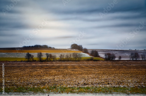 Midwestern fields with winter frost and rays of sunlight