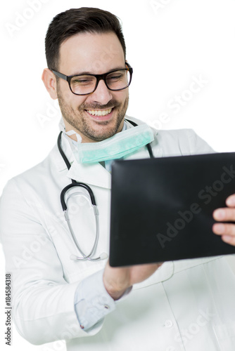 Smiling doctor using tablet
