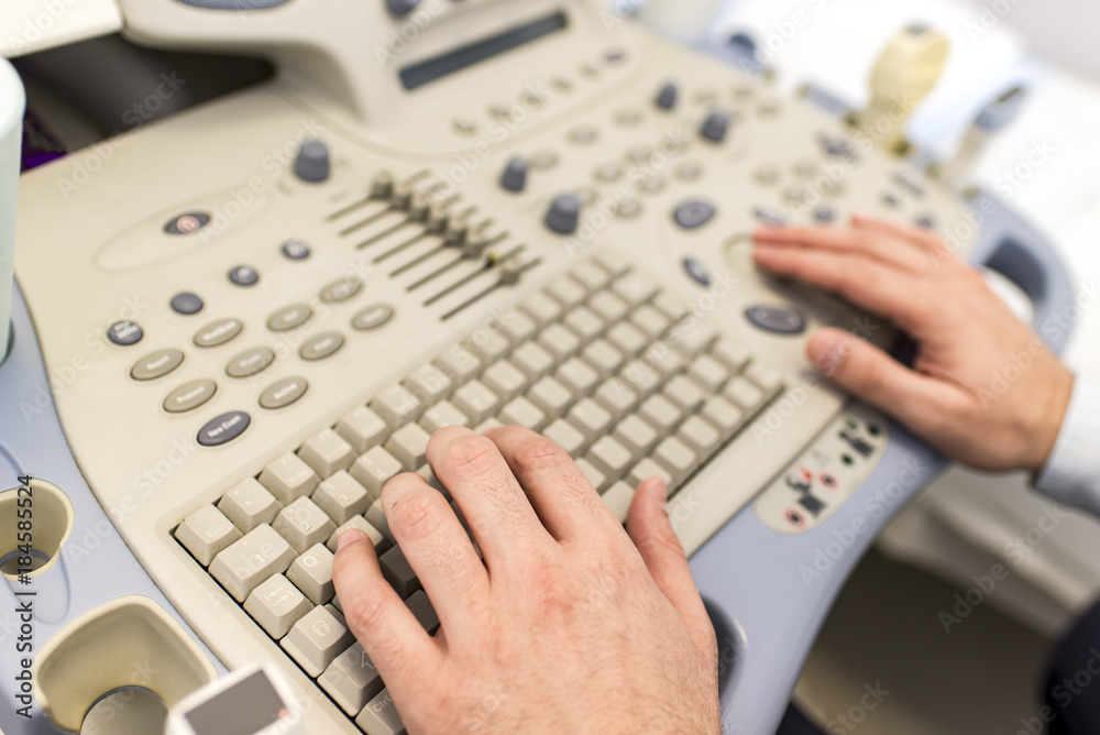 Doctor working on ultrasounds keyboard Doctor working on ultrasounds keyboard