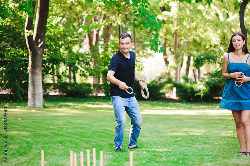 Friends plaing outdoor games - ring toss. Friends plaing outdoor games - ring toss.