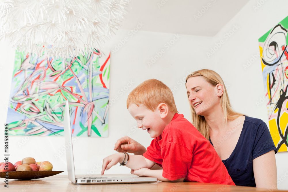 Mother and son using laptop together Mother and son using laptop together