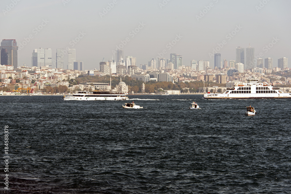 A skyline of Istanbul and the sea and ferry and boats on the move
