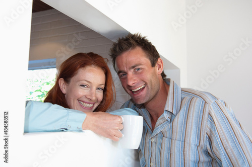 Smiling couple having coffee together