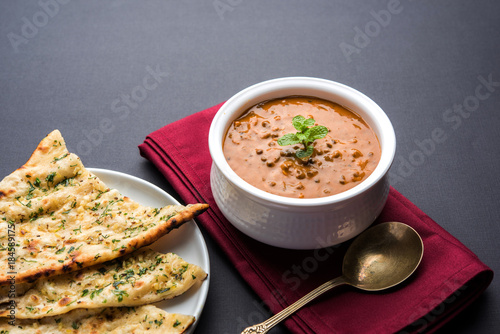 Dal makhani or dal makhni is a popular food from Punjab / India made using  whole black lentil, red kidney beans, butter and cream and served with garlic naan or Indian bread or roti


