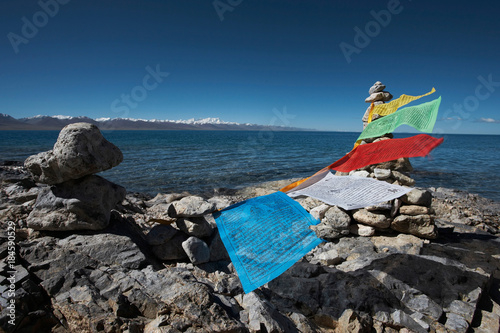 Prayer flags on rocky beach