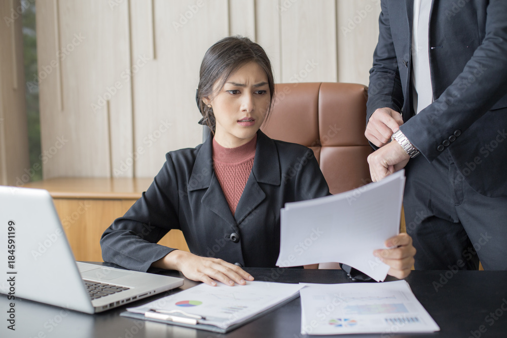 Upset woman being scolded by boss for working at office, Boss showing time for deadline job, woman with stressful concept Upset woman being scolded by boss for working at office, Boss showing time for deadline job, woman with stressful concept