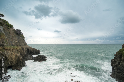Sea waves crashing on the rock. At Riomaggiore in La Spezia, One of the famous Cinque Terre, Italy