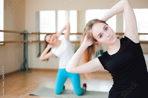 Fit smiling group doing exercise in gym