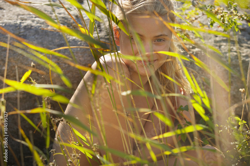 Young woman nude in long grass photo