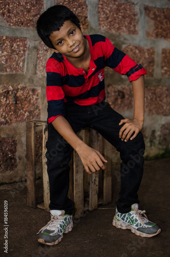 Boy sitting on wooden box photo