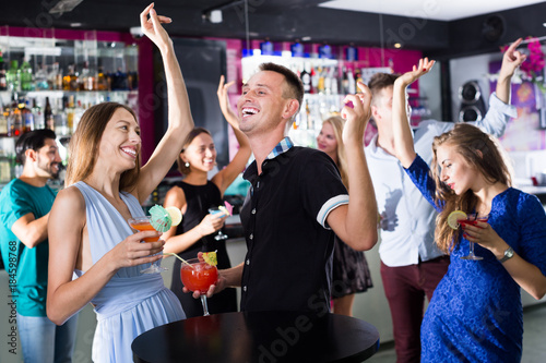 Students dancing on party in club