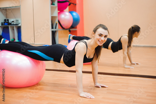 happy cutie athletic girl , execute exercise and smile, in sport-hall
