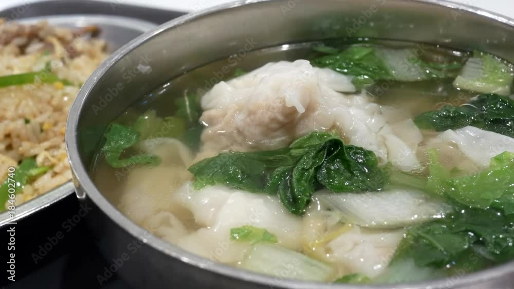 Motion of seafood dumpling soup on table inside restaurant with heavy steam Motion of seafood dumpling soup on table inside restaurant with heavy steam