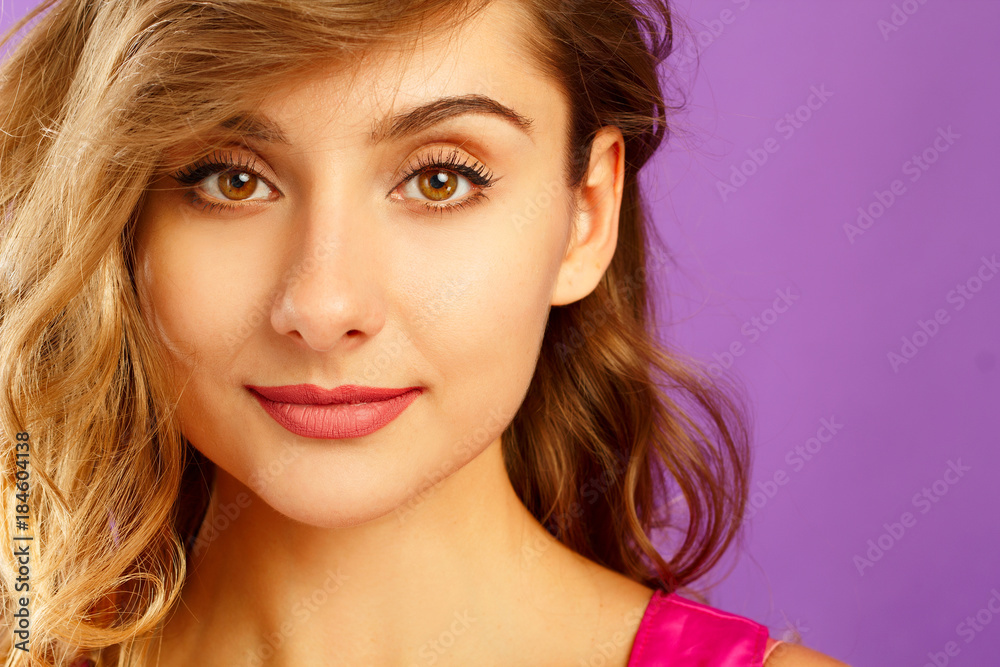 Beautiful young woman posing in studio over violet background. Fashion concept. Beautiful young woman posing in studio over violet background. Fashion concept.