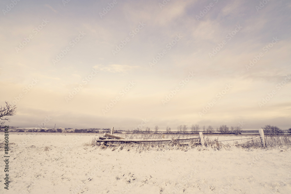 Wooden fence in a winter landscape