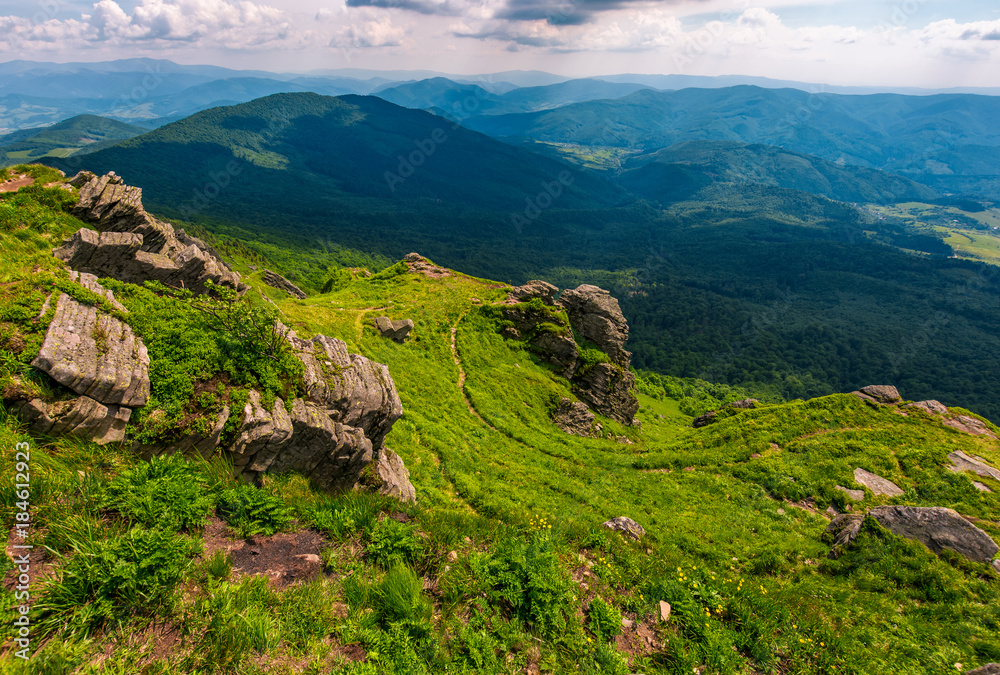 footpath among huge rocks on the edge of a hill. beautiful valley view from the top