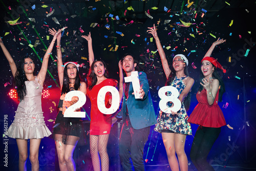 New Year 2018 Party - Group of Friends Enjoy Throwing Confetti and Dancing in Nightclub