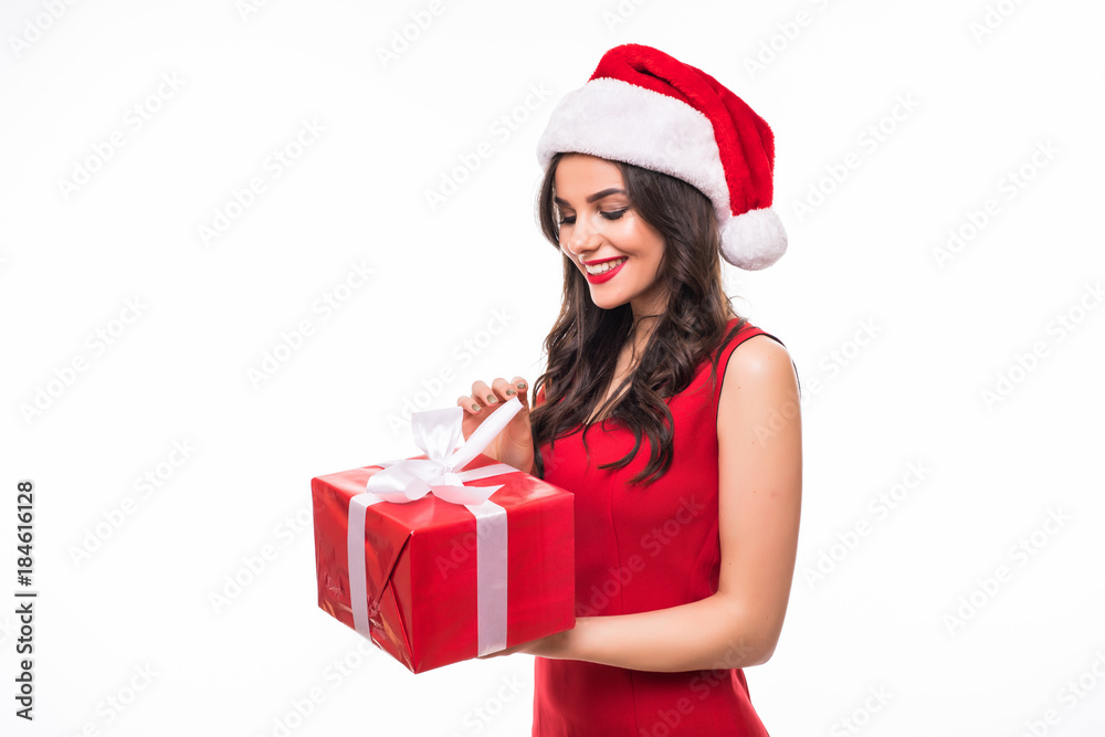 Cheerful young woman in santa hat with presents isolated on white background. Cheerful young woman in santa hat with presents isolated on white background.