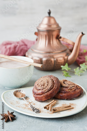 Tableau sur toile Close-up of a large cup of hot chocolate and fresh homemade cinnamon rolls on a vintage background