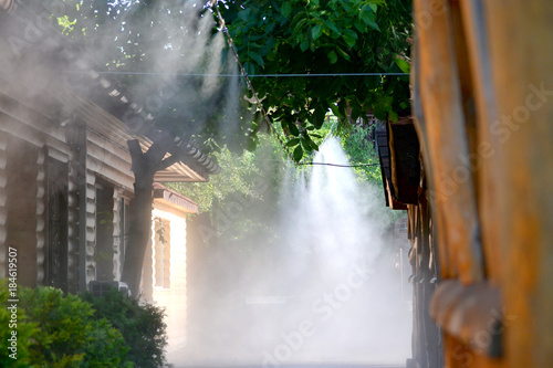 Irrigation system close-up. Humidification of air by steam on the street outdoor in a hot summer day morning